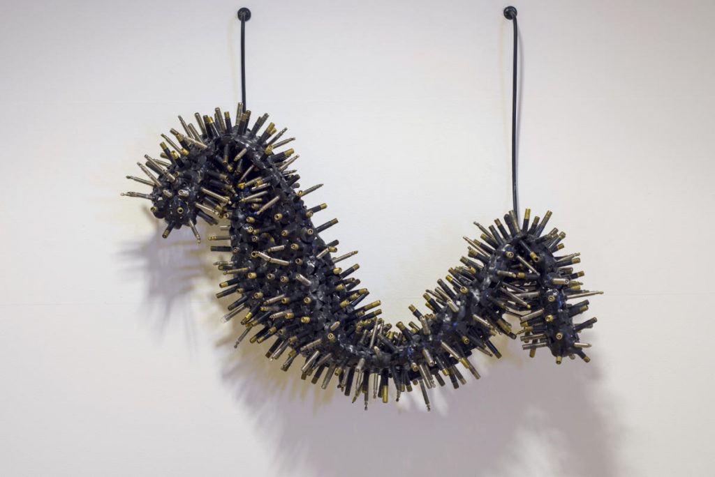 Evgeniya Martirosyan 'Chrysalis',  2020, 300 hand-stitched bicycle valves and two wall hooks. Courtesy of the Artist. Installation view in 'Under Skin 7', The Lab, Dublin by Louis Haugh.