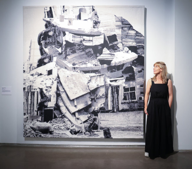 DKANE 8th September 2023 REPRO FREE Artist Ailbhe Ní Bhriain with her work Intrusions III at the opening of Following Threads  a new exhibition at Crawford Art Gallery. The exhibition shows a selection of artworks featuring tapestry, embroidery, rug making, drawing in thread, sculpture and quilting. The artworks are informed by an exploration of technique, colour, pattern and shape, as well as exploring themes of labour and reproduction, memory and history.  Photo Darragh Kane