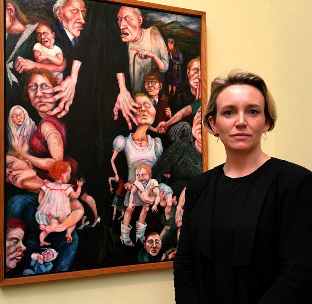 Ireland Portrayed: Cristín Leach in front of Rita Duffy's painting Segregation (1989)